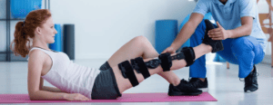 Physiotherapist assisting a patient with mobility exercises during postoperative rehabilitation.